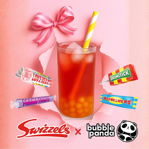 Glass of iced tea with a straw, surrounded by Swizzles candy bars on a pink background