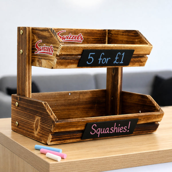 Wooden display stand with 'Swizzles' branding and chalkboard labels on a wooden surface.