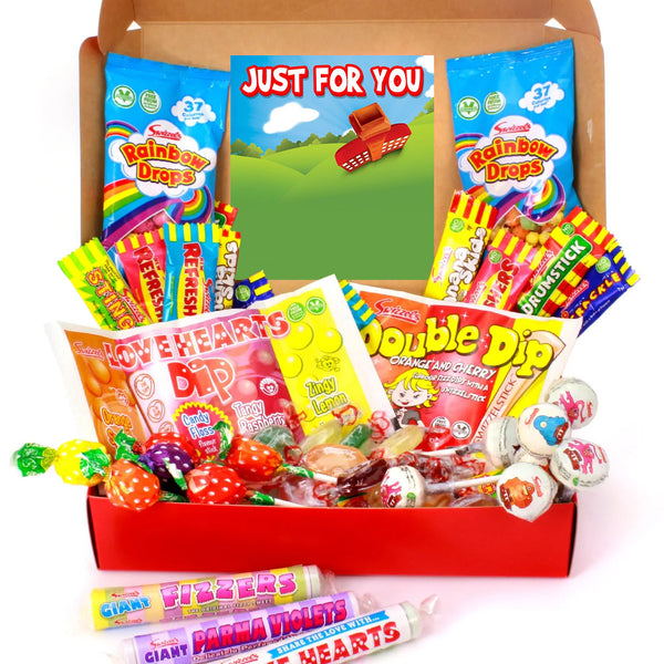 A large candy gift box filled with assorted sweets, lollipops, and candy bars, including Rainbow Drops, Double Dip, Love Hearts Dip, and Parma Violets, arranged in a red box with a green insert card.