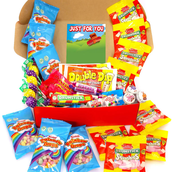 A children's candy gift box filled with assorted packaged sweets, lollipops, and a small card reading 'JUST FOR YOU.' The box is open and surrounded by colorful candy bags, including Rainbow Drops, Double Dip, and Drumstick brands, on a plain white background.
