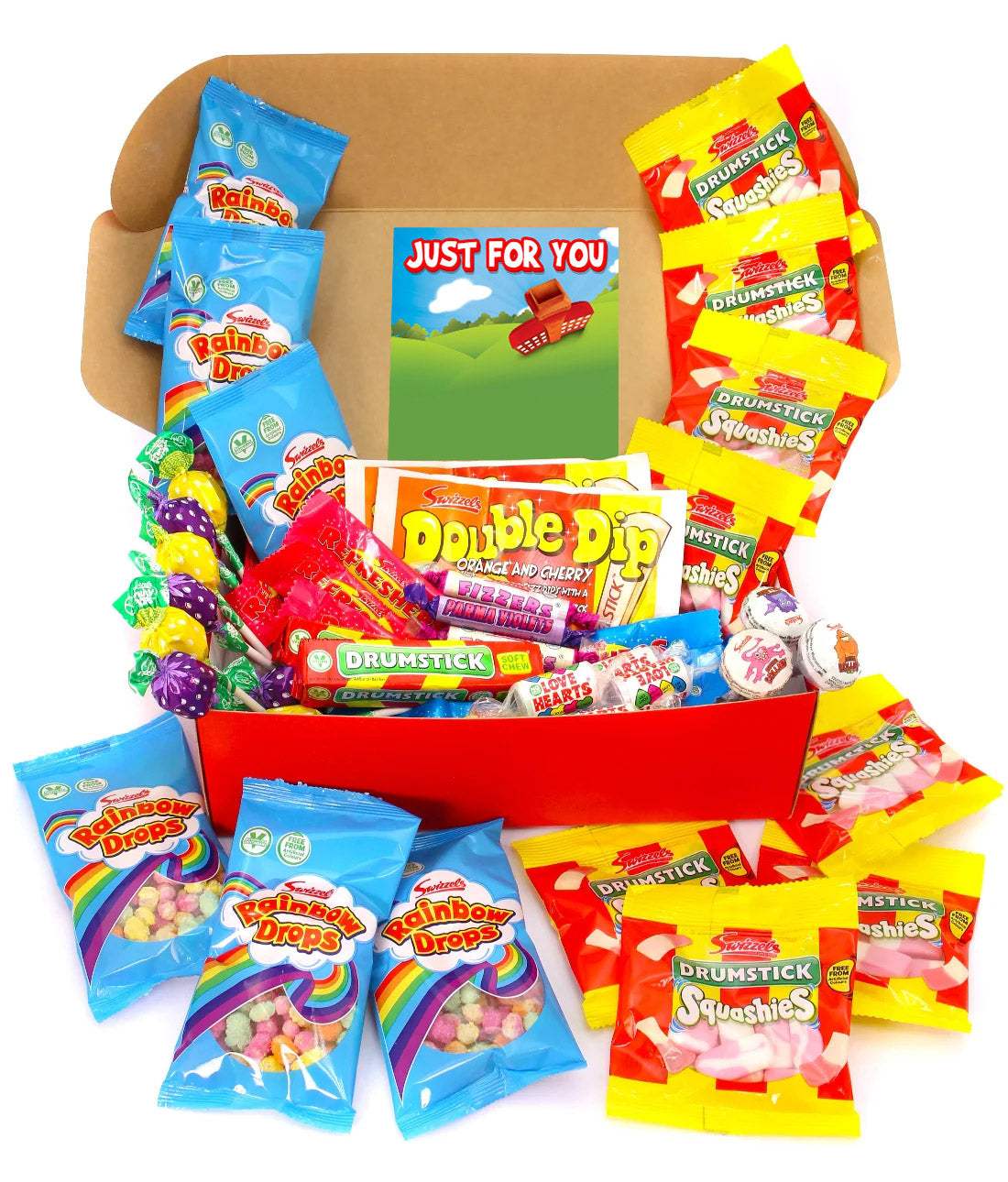 A children's candy gift box filled with assorted packaged sweets, lollipops, and a small card reading 'JUST FOR YOU.' The box is open and surrounded by colorful candy bags, including Rainbow Drops, Double Dip, and Drumstick brands, on a plain white background.