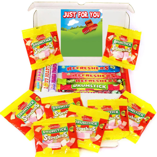 A white gift box filled with assorted candy, including multiple yellow and red Drumstick Squishies bags, a row of Refreshers bars, and a card that reads 'JUST FOR YOU' on a white background.