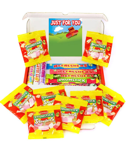 A white gift box filled with assorted candy, including multiple yellow and red Drumstick Squishies bags, a row of Refreshers bars, and a card that reads 'JUST FOR YOU' on a white background.