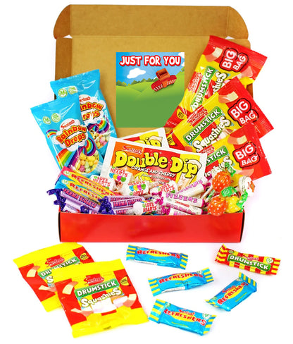 A curated candy gift box filled with assorted branded sweets and wrapped candies, shown open on a white background. Visible brands include Double Dip, Drumstick, Big Bag, and Snickersaas.
