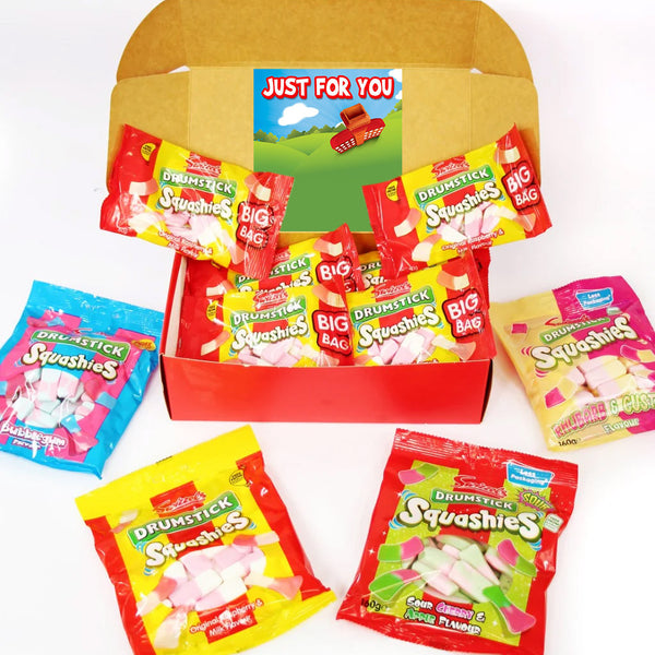 A red gift box filled with Drunkstick Squashies candy bags, surrounded by additional Drunkstick Squashies candy bags on a white background.