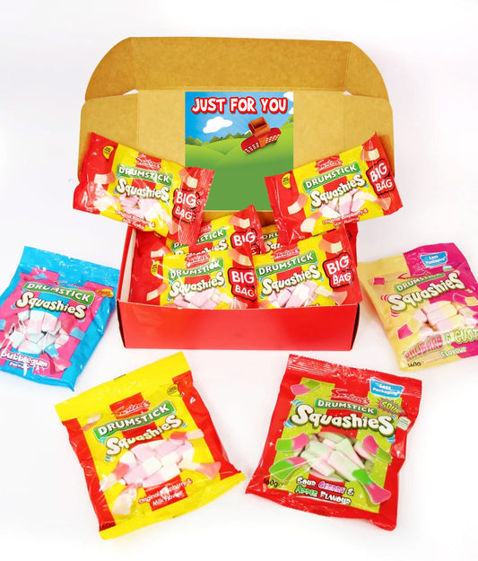 A red gift box filled with Drunkstick Squashies candy bags, surrounded by additional Drunkstick Squashies candy bags on a white background.