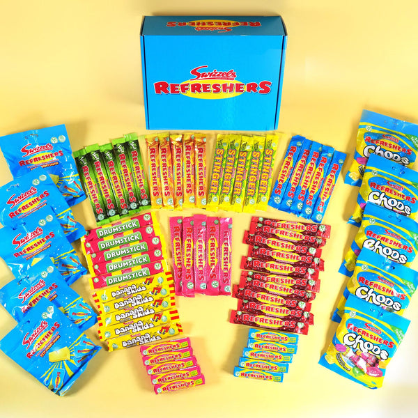 A collection of Snickers Fresh Refreshers candy products arranged in a pyramid pattern around a blue box on a yellow background. The assortment includes various colorful individually wrapped stick packs and bagged candies.