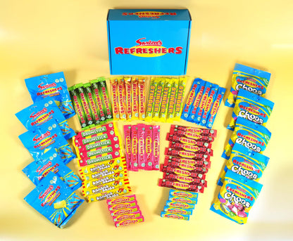 A collection of Snickers Fresh Refreshers candy products arranged in a pyramid pattern around a blue box on a yellow background. The assortment includes various colorful individually wrapped stick packs and bagged candies.