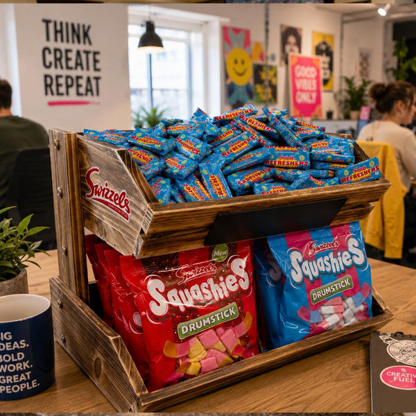Display of Swizzles sweets including Squishies and Drumsticks in a office setting.